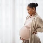 Black pregnant woman thinking about pregnancy
